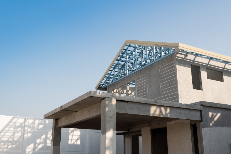 structure of steel roof frame for building construction on sky background.